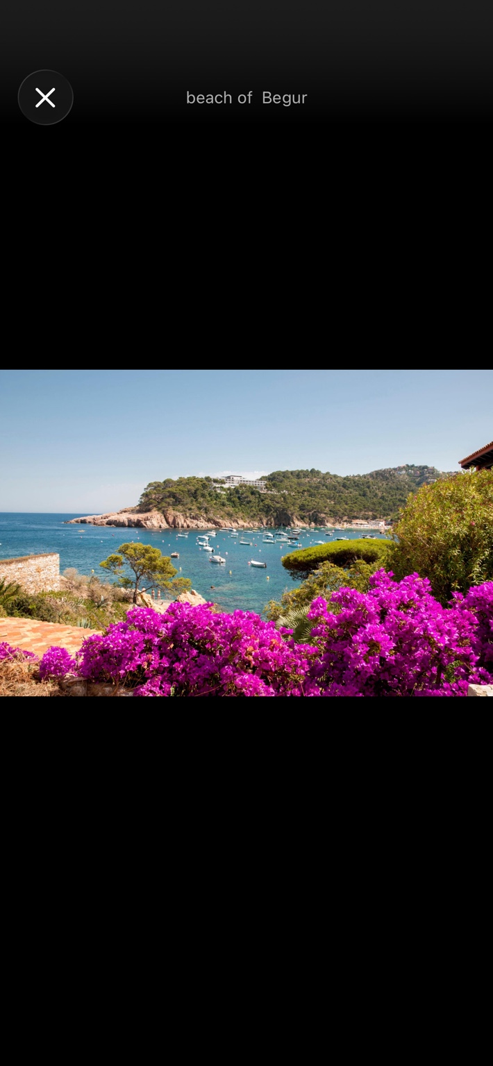 Costa Brava bay framed by pink bougainvillea