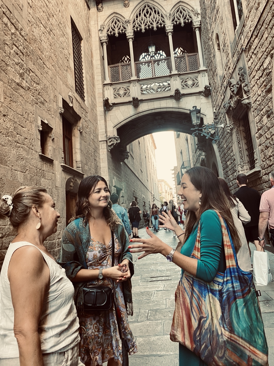 Juliana sharing stories with travelers beneath Pont del Bisbe in Barcelona’s Gothic Quarter