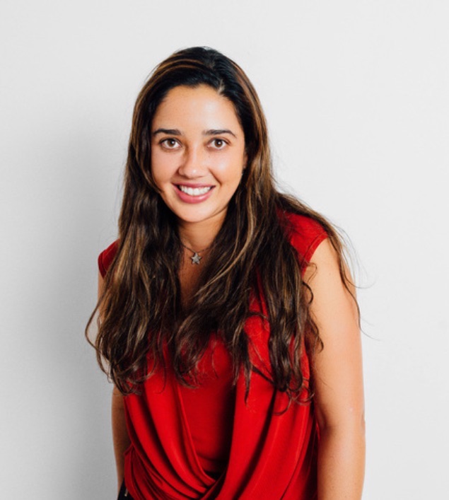 Juliana Gómez Ríos, founder of Volarte, smiling in a red blouse