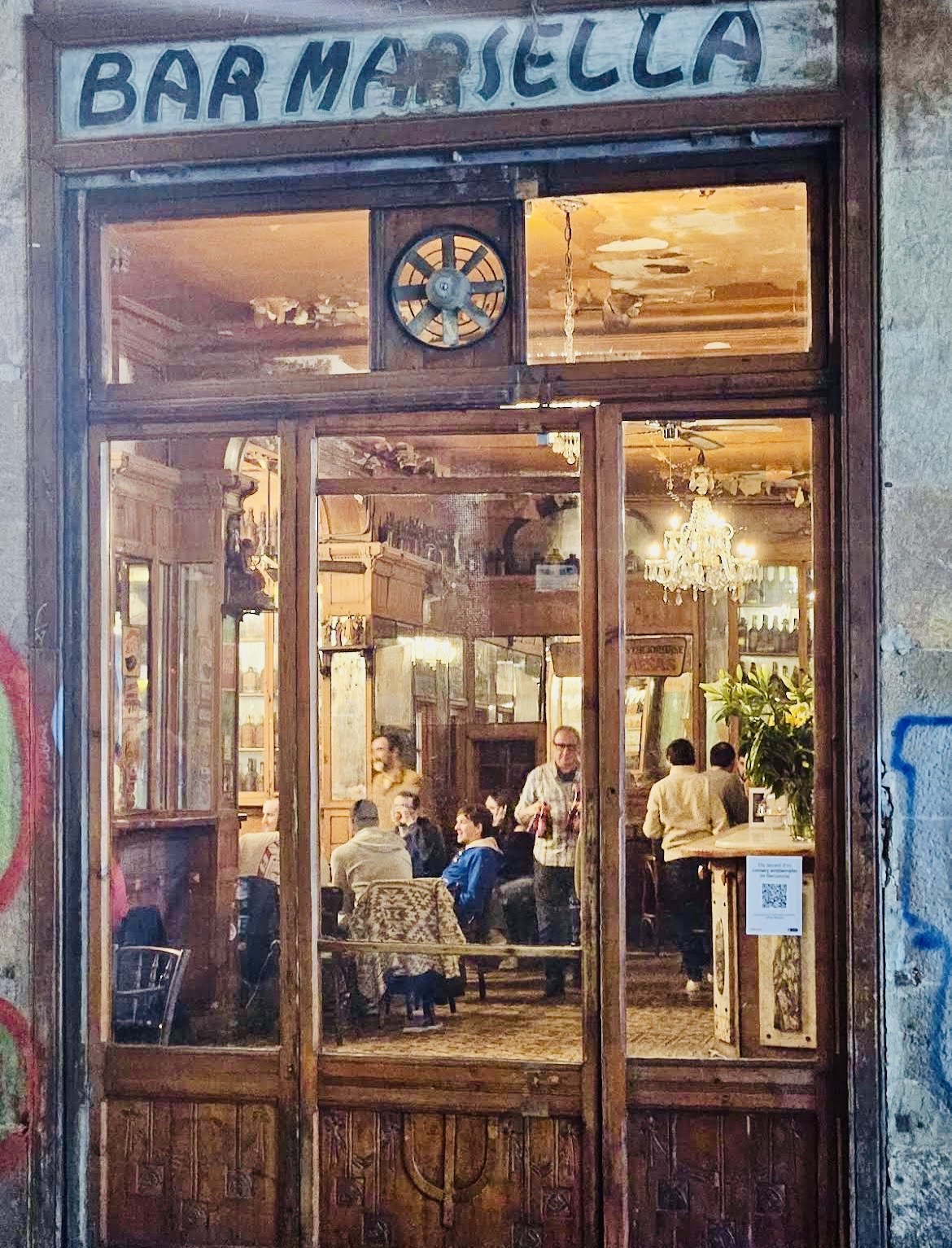 The entrance to Bar Marsella, with guests chatting inside
